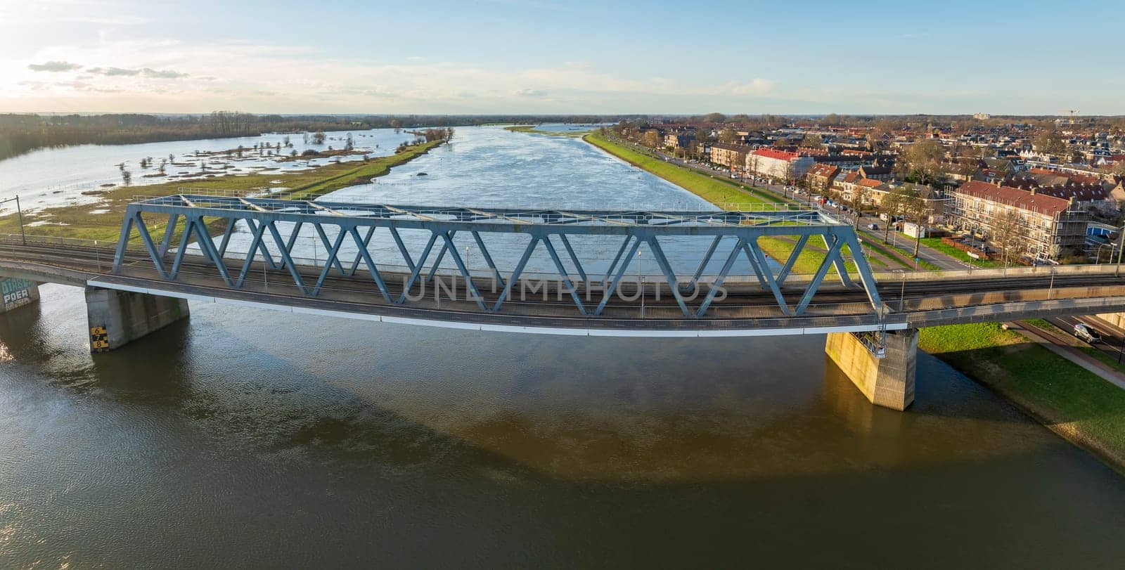 aerial shot of the Deventer railroad bridge over the ijssel river in the Netherlands