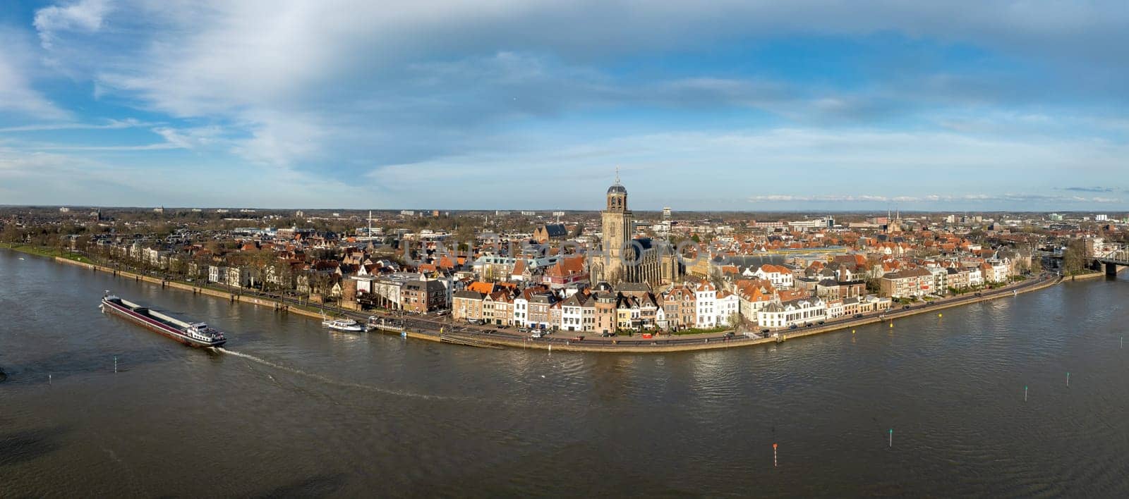 aerial panoramic shot of the Dutch city of Deventer, along the IJssel river.