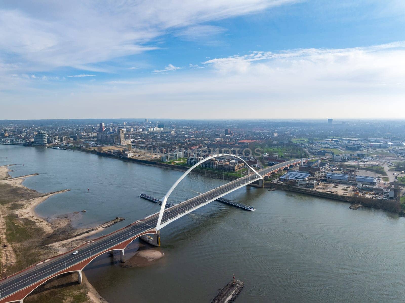 aerial view of a modern bridge called "De Oversteek"" (the Crossing) in Nijmegen, the Netherlands. It crosses the Waal river"