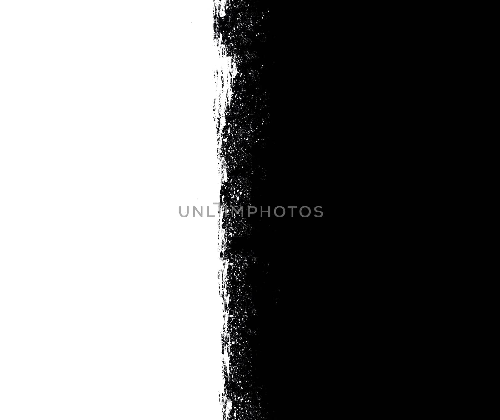 Black and white split surface with uneven edges close-up from above