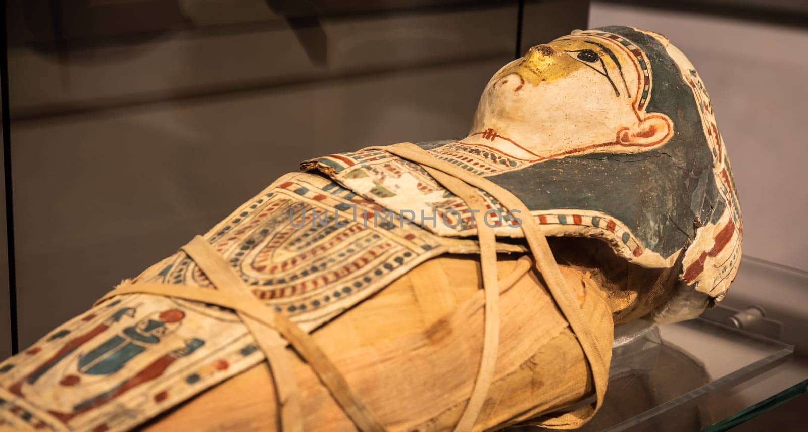 Turin, Italy - March 2023: Egyptian Museum, mummy of a baby with a mask - 2nd Century BC