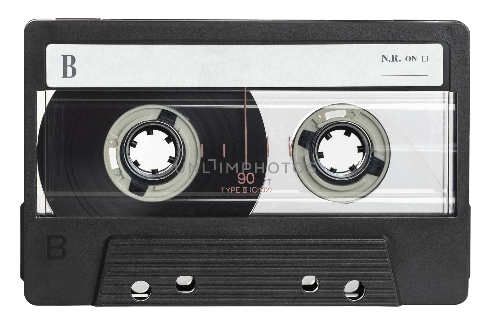 Classic black audio cassette tape with a blank label, isolated on a white background