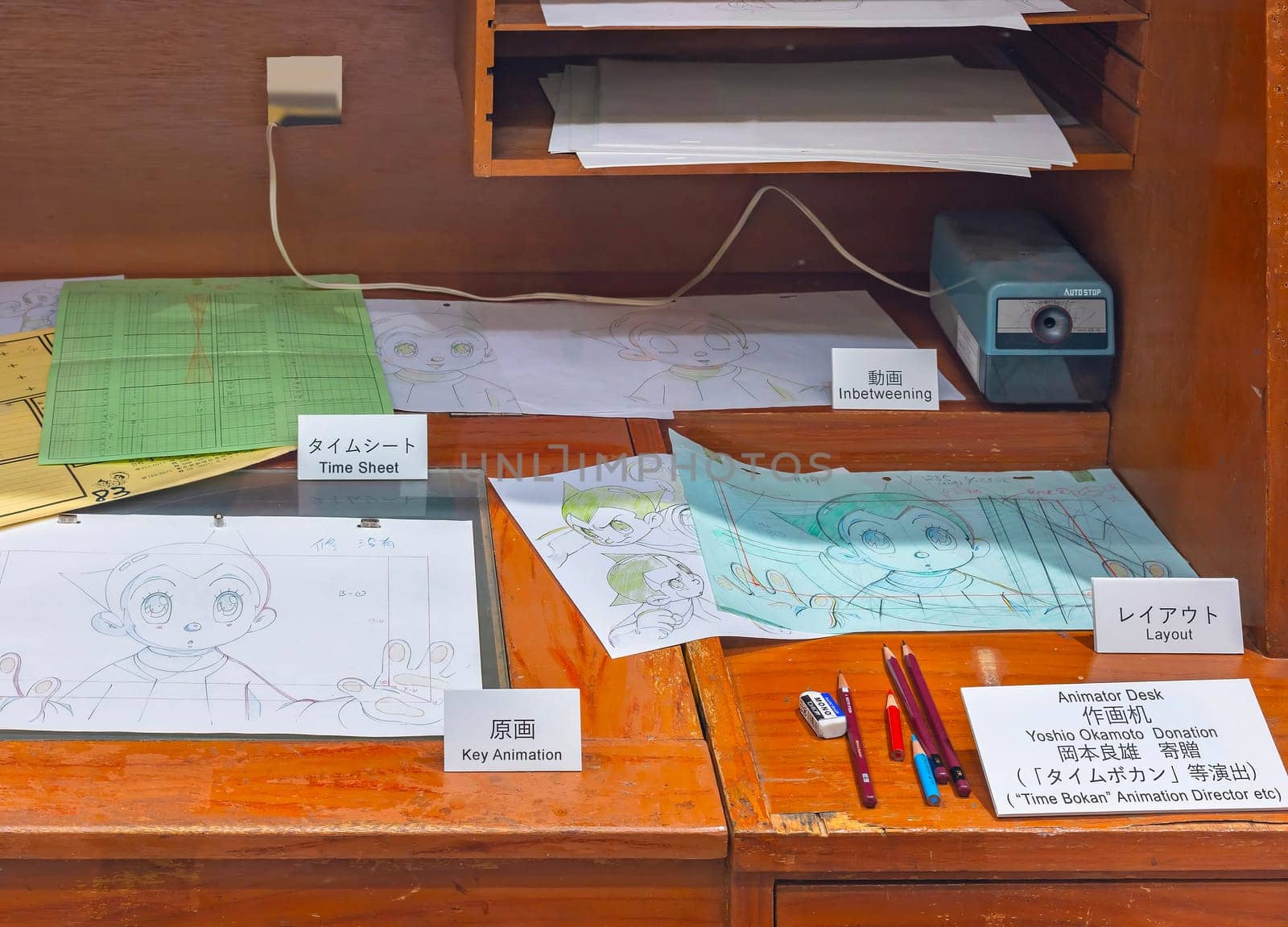ikebukuro, japan - jan 16 2024: Animator desk exhibited at the free entry museum of Tokyo Anime Station featuring different stages of the creation of an animation illustrated with Astro boy character.