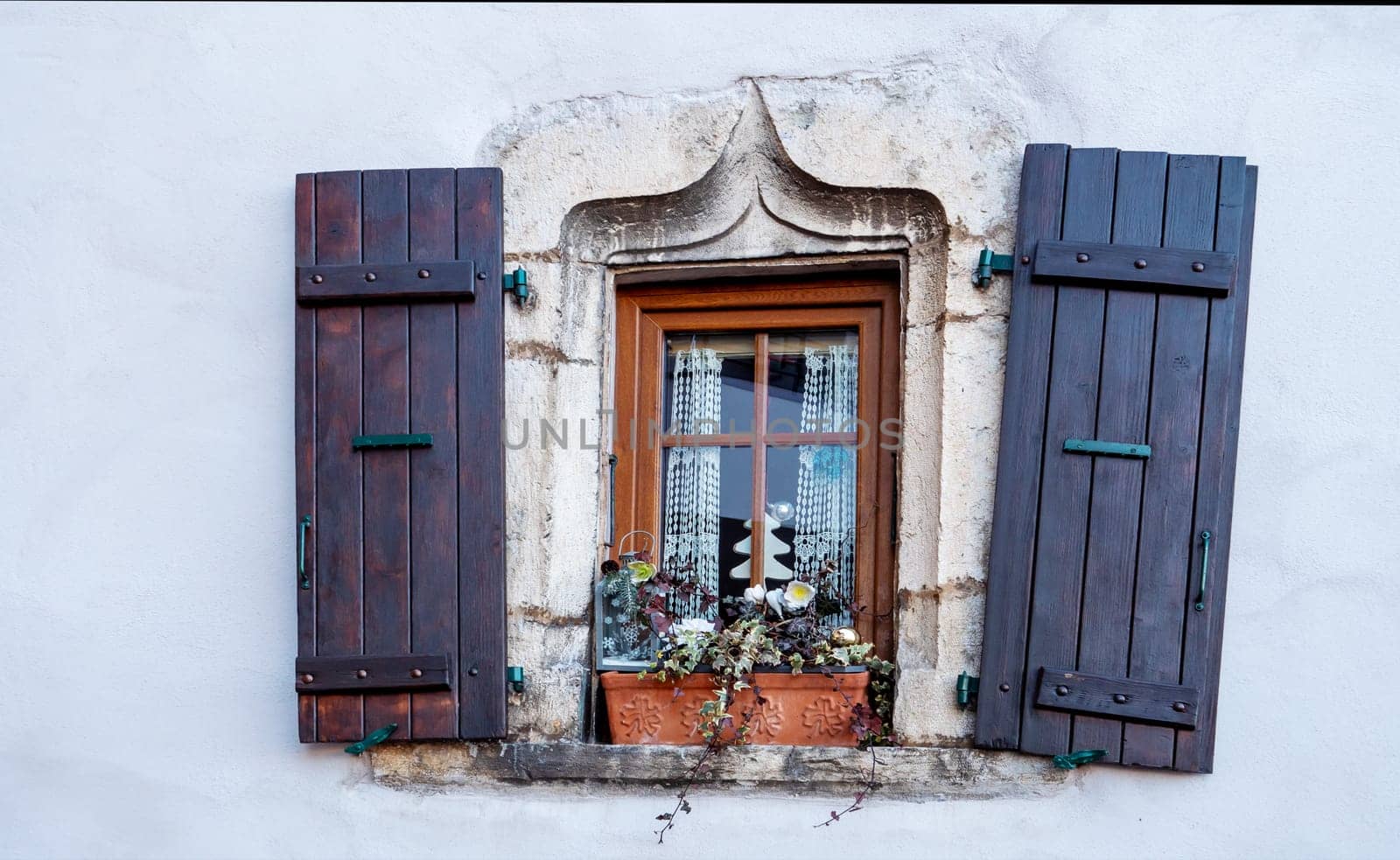 an old wooden window on old wall.