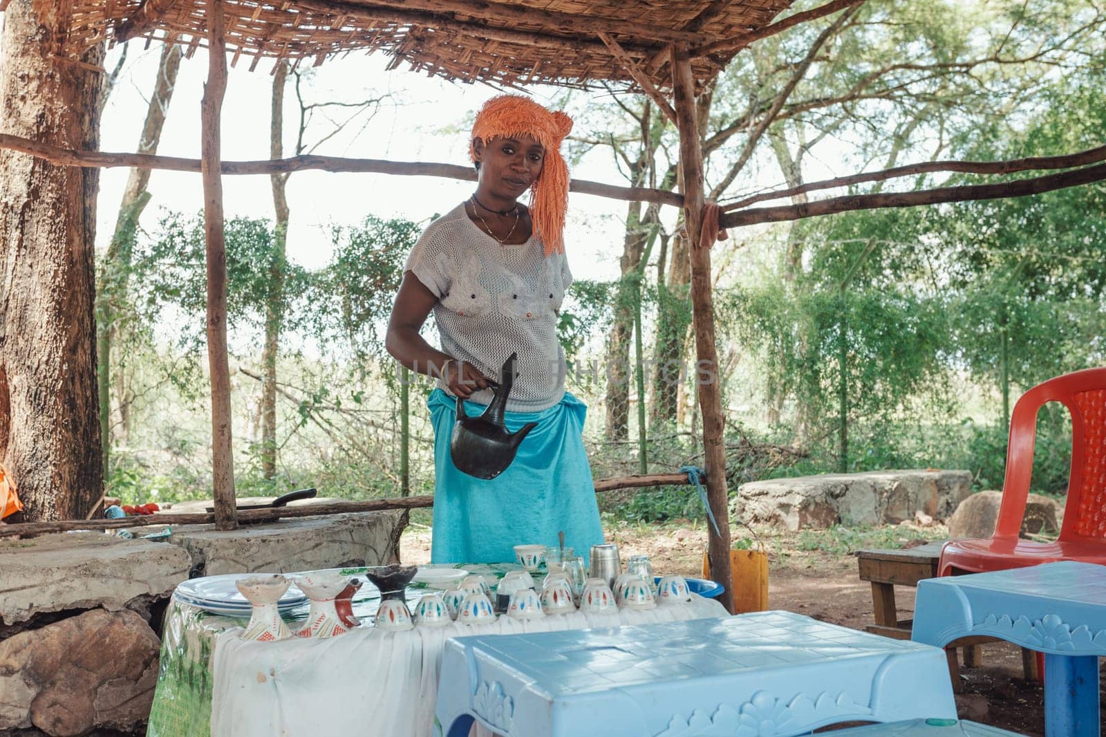Southern Nations, Ethiopia - April 27, 2019: Woman perform a traditional Ethiopian coffee ceremony, preparing street bunna coffee.