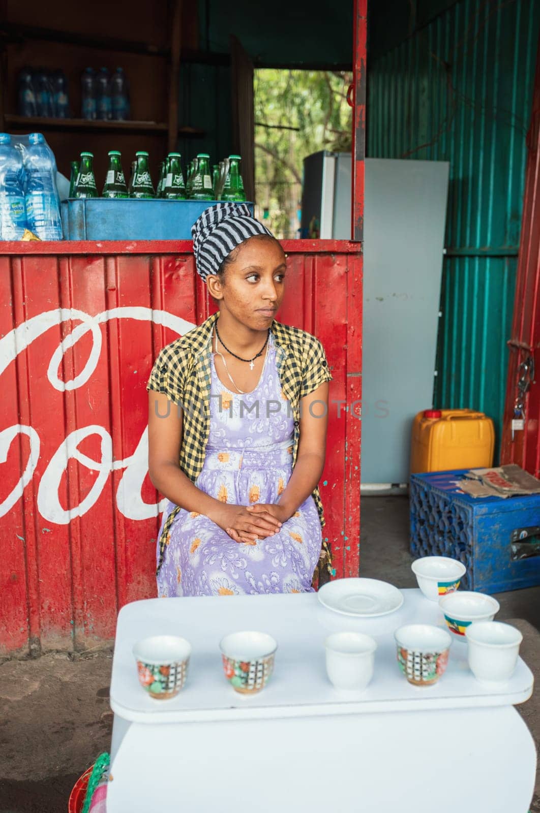 Adis Zemen, Ethiopia - April 27, 2019: Woman perform a traditional Ethiopian coffee ceremony, preparing street bunna coffee.
