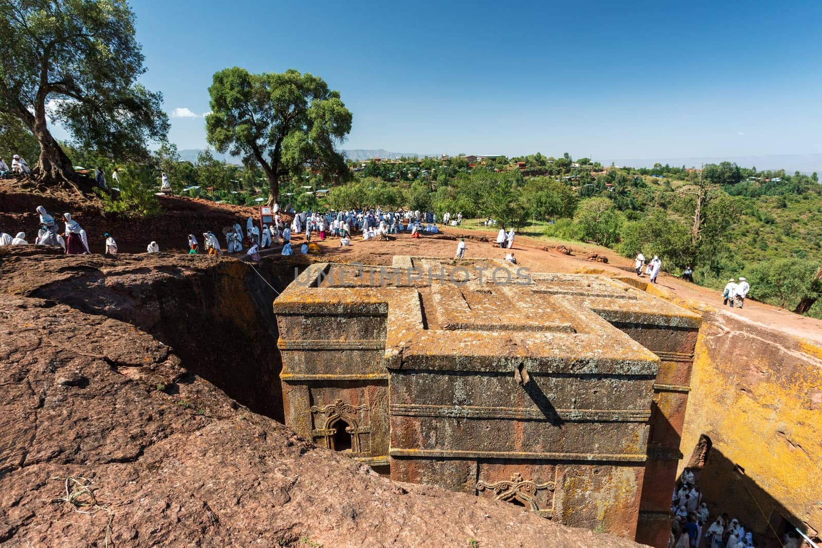 Lalibela, Ethiopia - May 1, 2019: Orthodox Ethiopians unwind at St. George Church after Mass. A serene moment capturing faith and cultural richness.