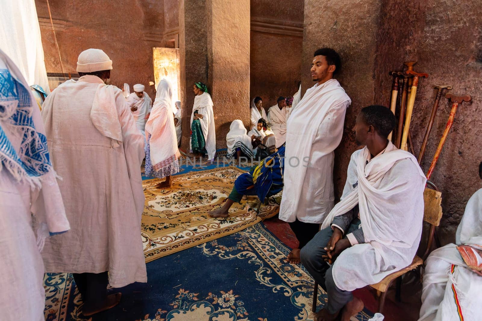 Lalibela, Ethiopia - May 1, 2019: A poignant image of worshippers praying inside St. George Church, Lalibela, capturing the spiritual devotion on May 1, 2019.