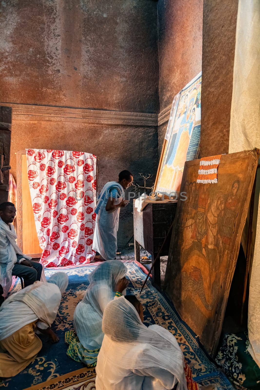 Lalibela, Ethiopia - May 1, 2019: A poignant image of worshippers praying inside St. George Church, Lalibela, capturing the spiritual devotion on May 1, 2019.