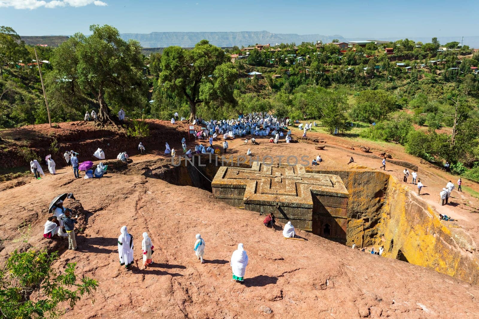 Lalibela, Ethiopia - May 1, 2019: Orthodox Ethiopians unwind at St. George Church after Mass. A serene moment capturing faith and cultural richness.
