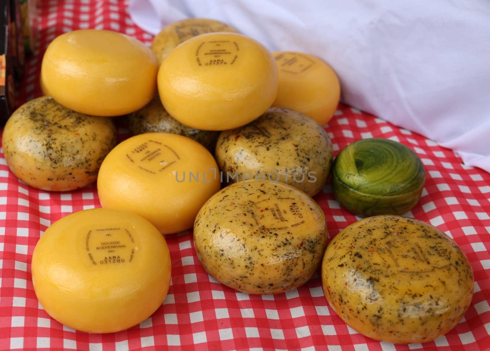 Gouda, the Netherlands - April 20, 2023: Traditional Dutch Gouda cheese at a street stall on Thursday traditional cheese market  day in Gouda, the Netherlands