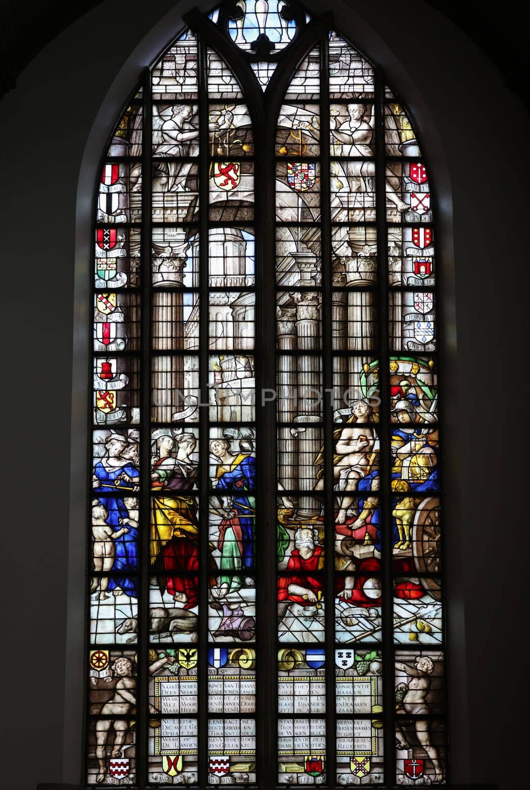 Gouda, the Nehterlands - April 20, 2023: The Stained glass window the Freedom of Conscience by Joachim Wtewael in the Sint Janskerk in Gouda, the Nehterlands