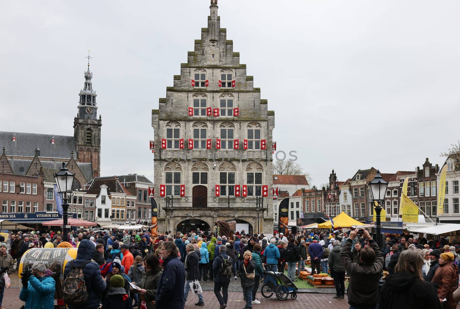 Gouda, the Nehterlands - April 20, 2023: The famous cheese market at the town hall in Gouda, the Nehterlands