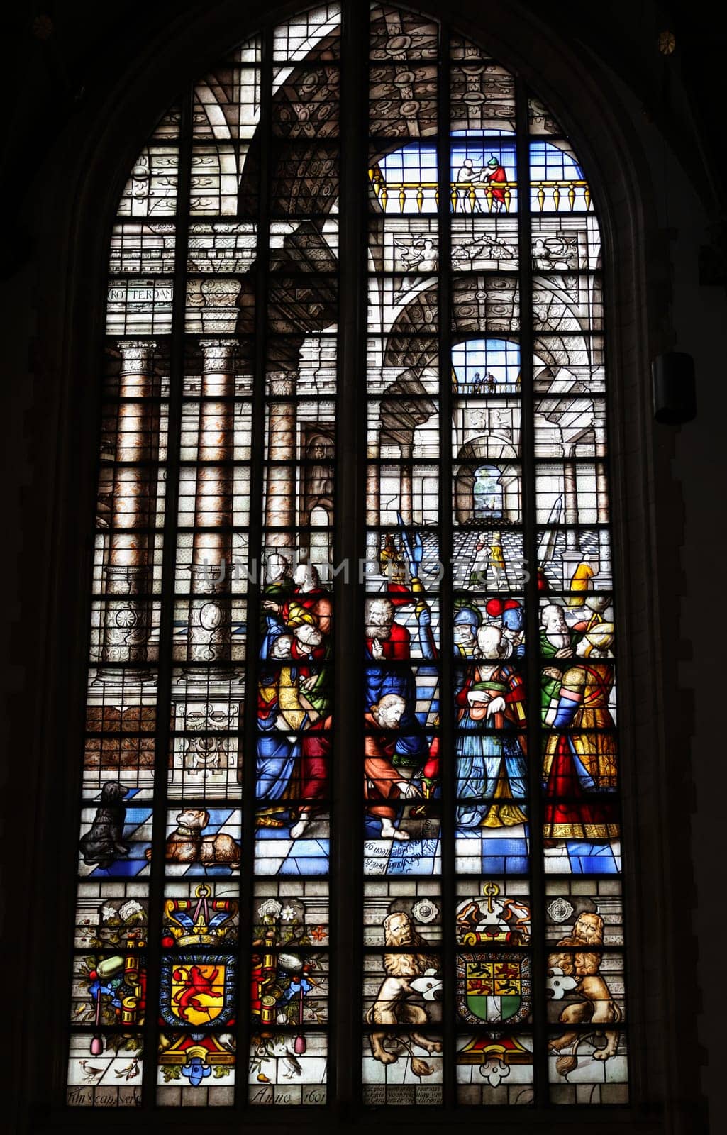 Gouda, the Nehterlands - April 20, 2023: The Stained glass window Jesus and the adultress by Claes Wytmans in the Sint Janskerk in Gouda, the Nehterlands
