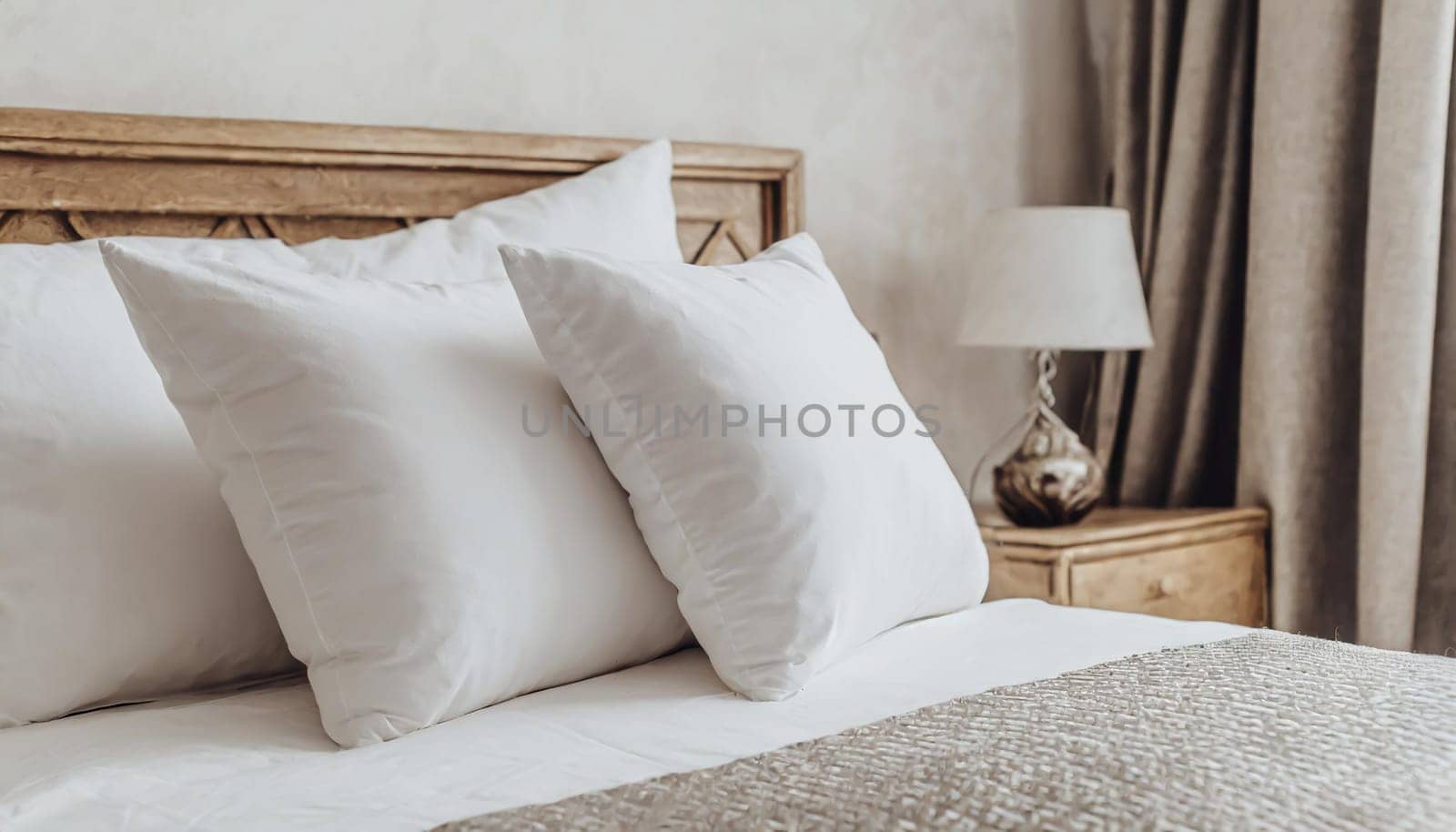Clean Bedding sheets and pillow on natural wall room background. White bedding and pillow in hotel room. White pillows on empty bed.
