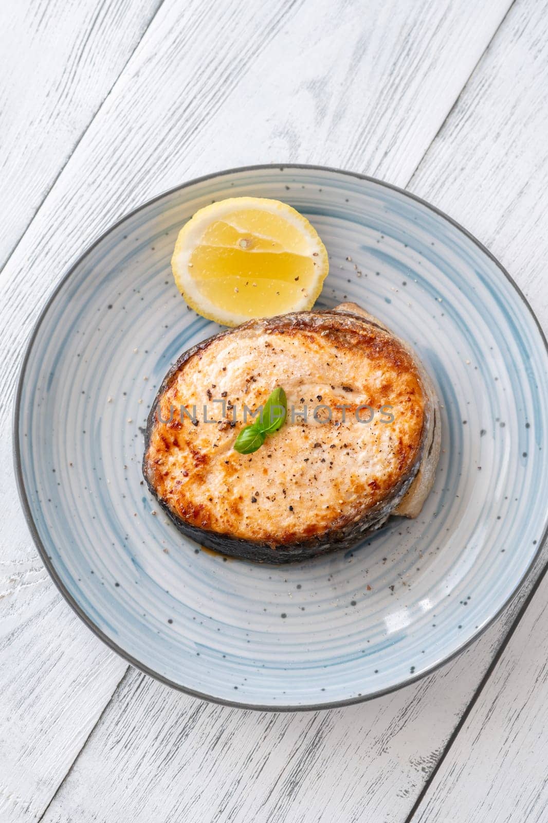 Portion of cooked salmon medallion with lemon