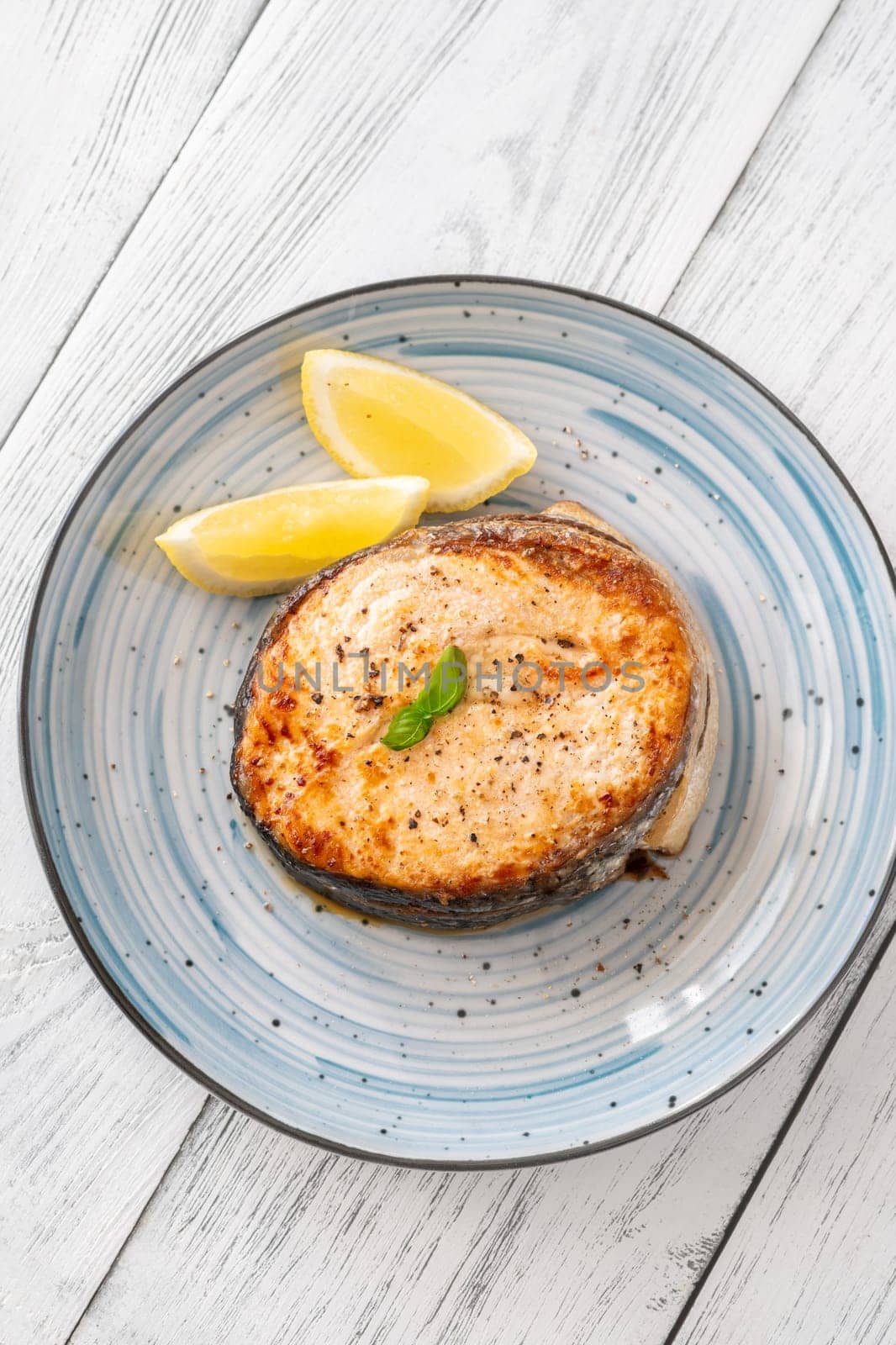 Portion of cooked salmon medallion with lemon