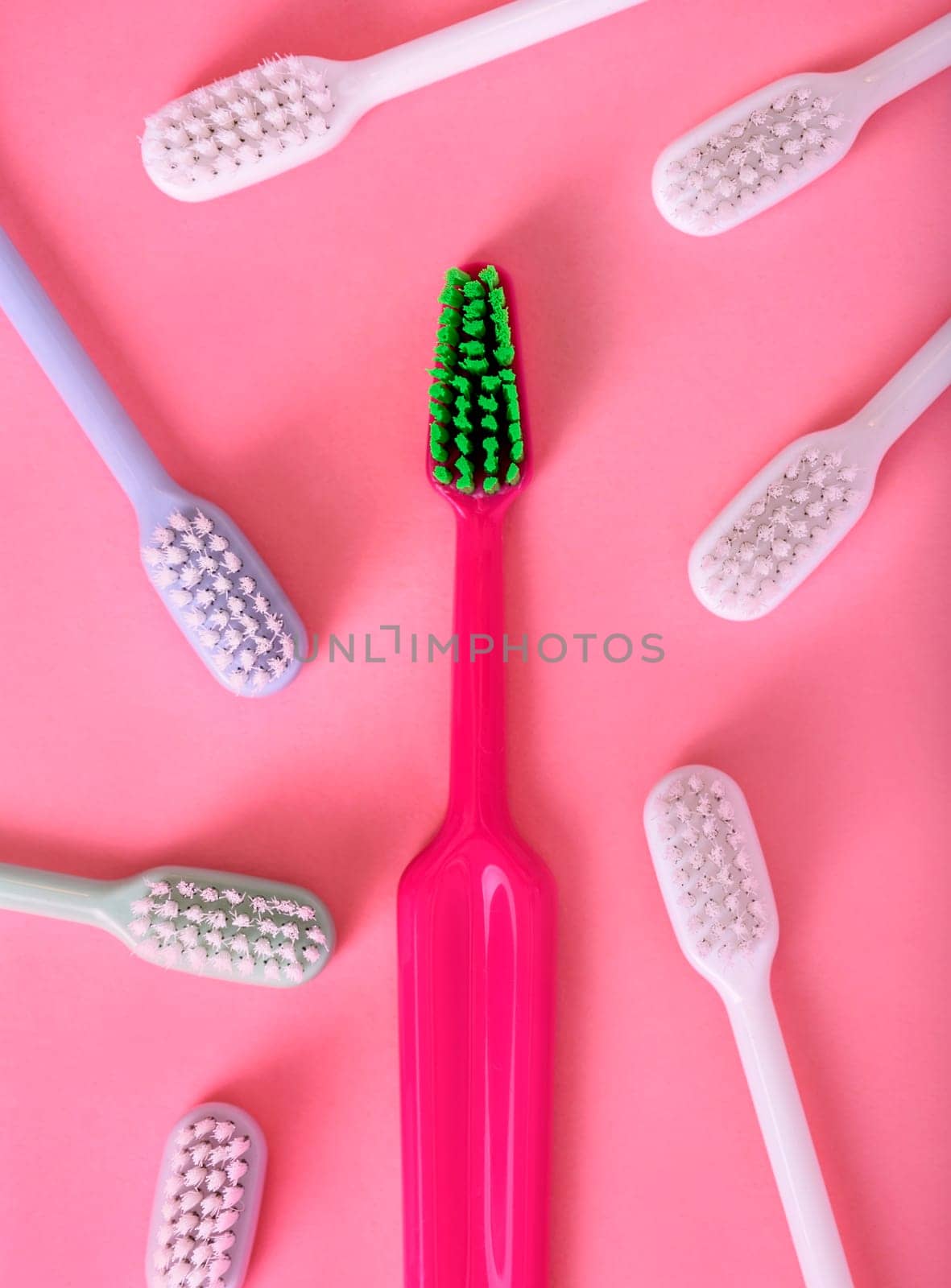 Different pastel tooth brushes pattern on color background. Many toothbrush choices for dental care and oral prevention hygiene. Family teethcare dentist concept. Minimal flat lay.