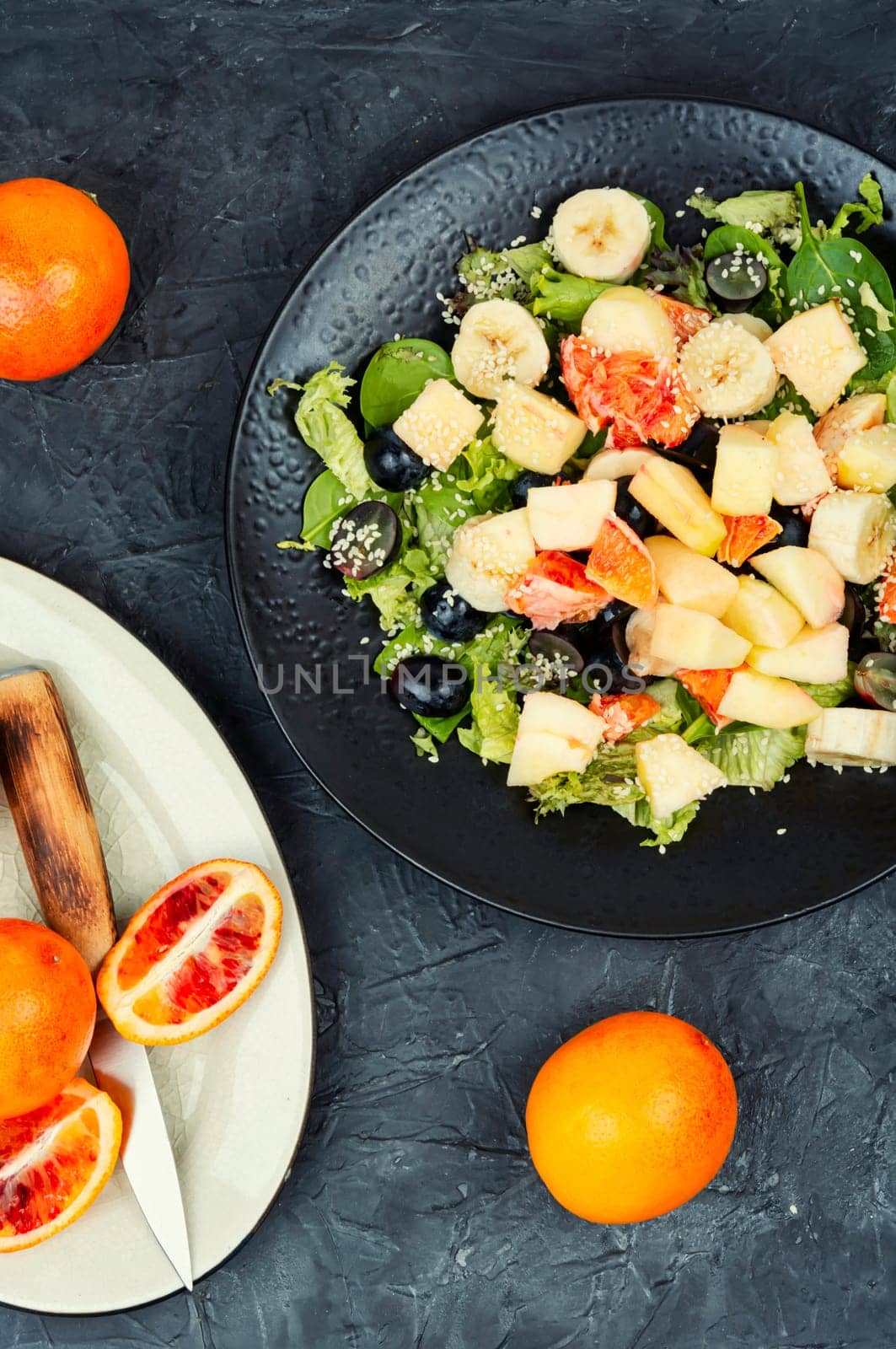 Fruit salad of red orange, apple, banana and herbs. Keto or paleo diet