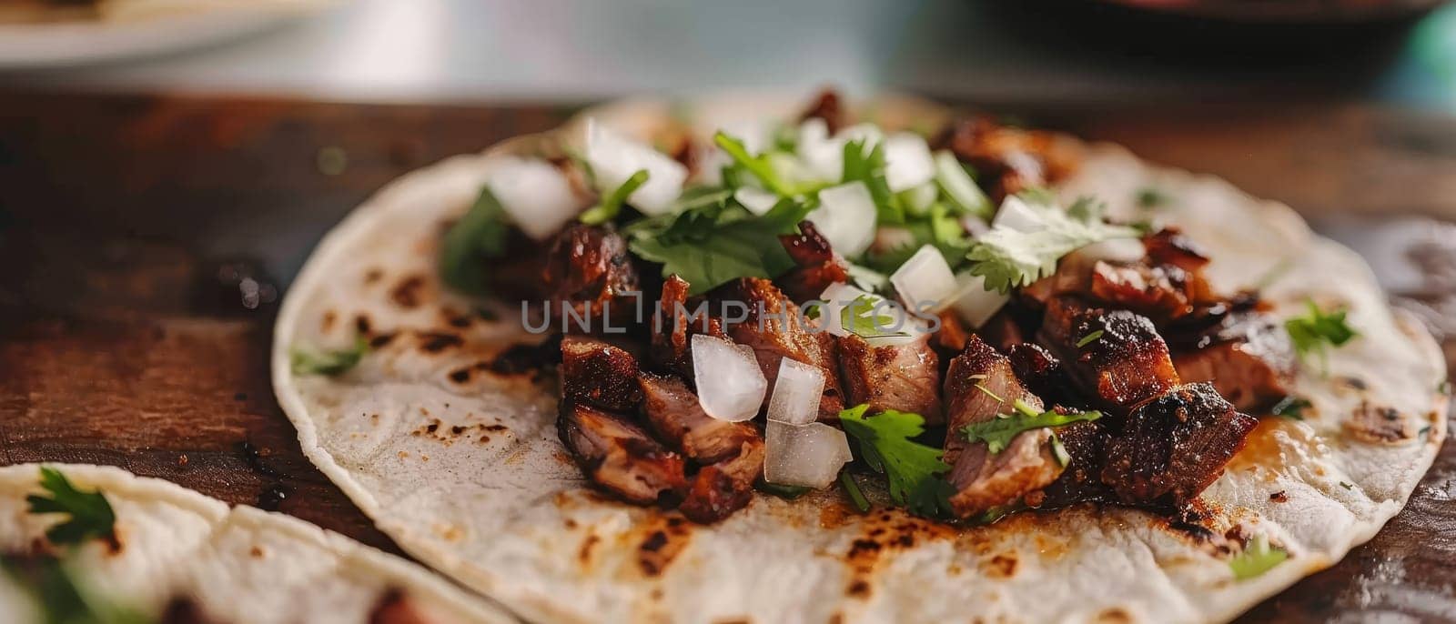Delicious taco with grilled meat, chopped onions, and fresh cilantro on a rustic surface