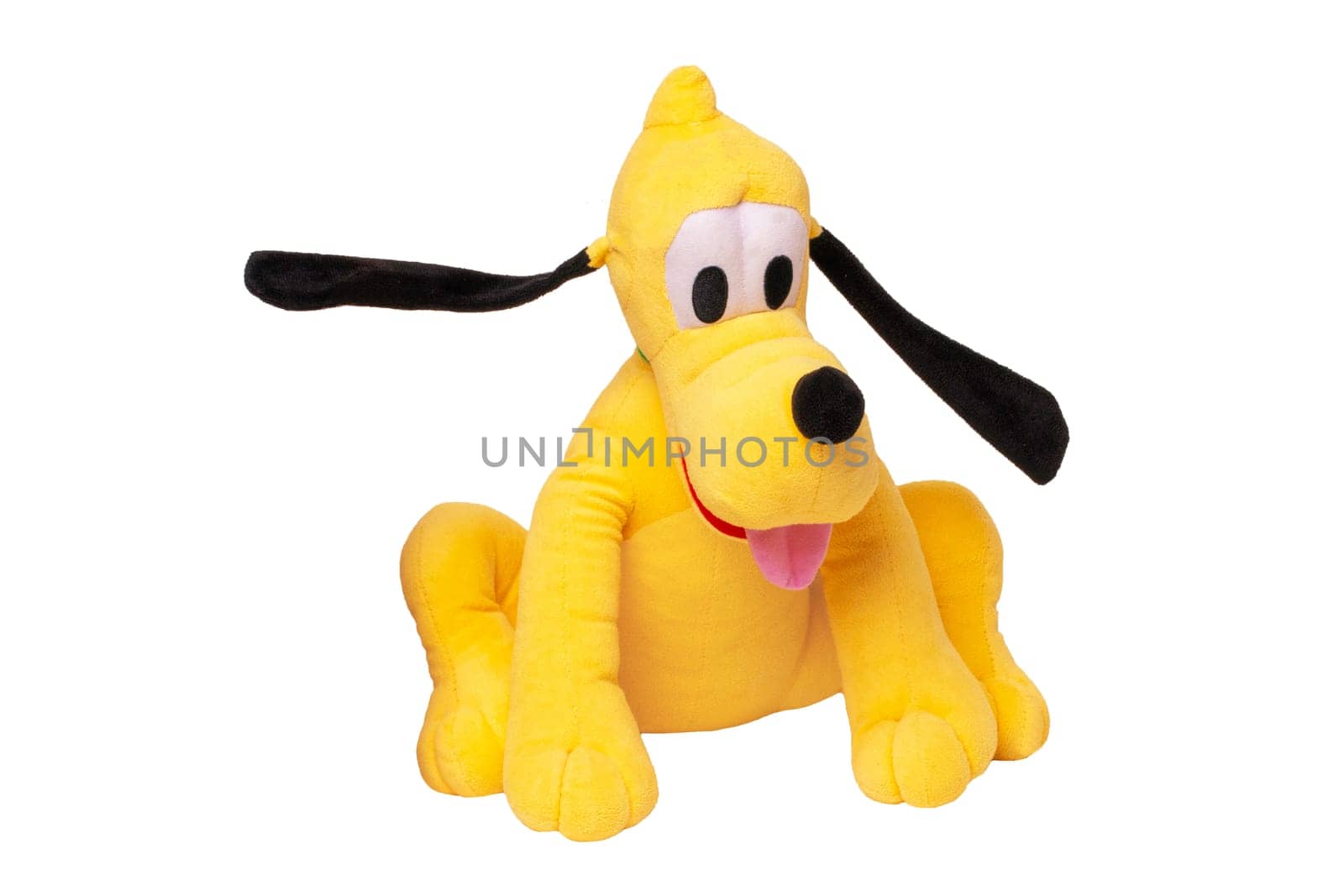 Children's toy stuffed animals. Close up of a playful yellow funny cute sitting toy plush toy dog isolated white background.