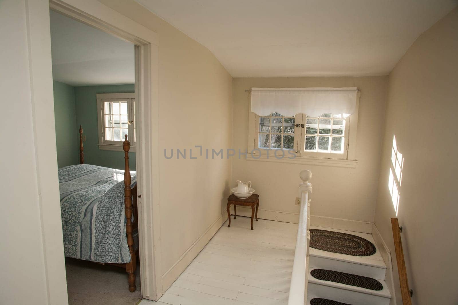 A hallway and bedroom in an old home.