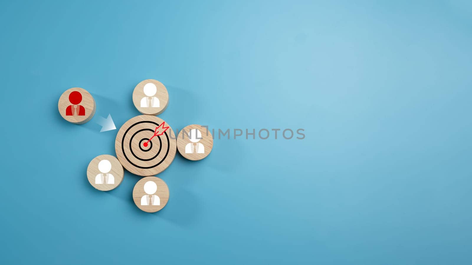 Circular wood with printed target icons and business symbols on light blue background, business goals and objectives concept, business competition, Customer relationship management concept.