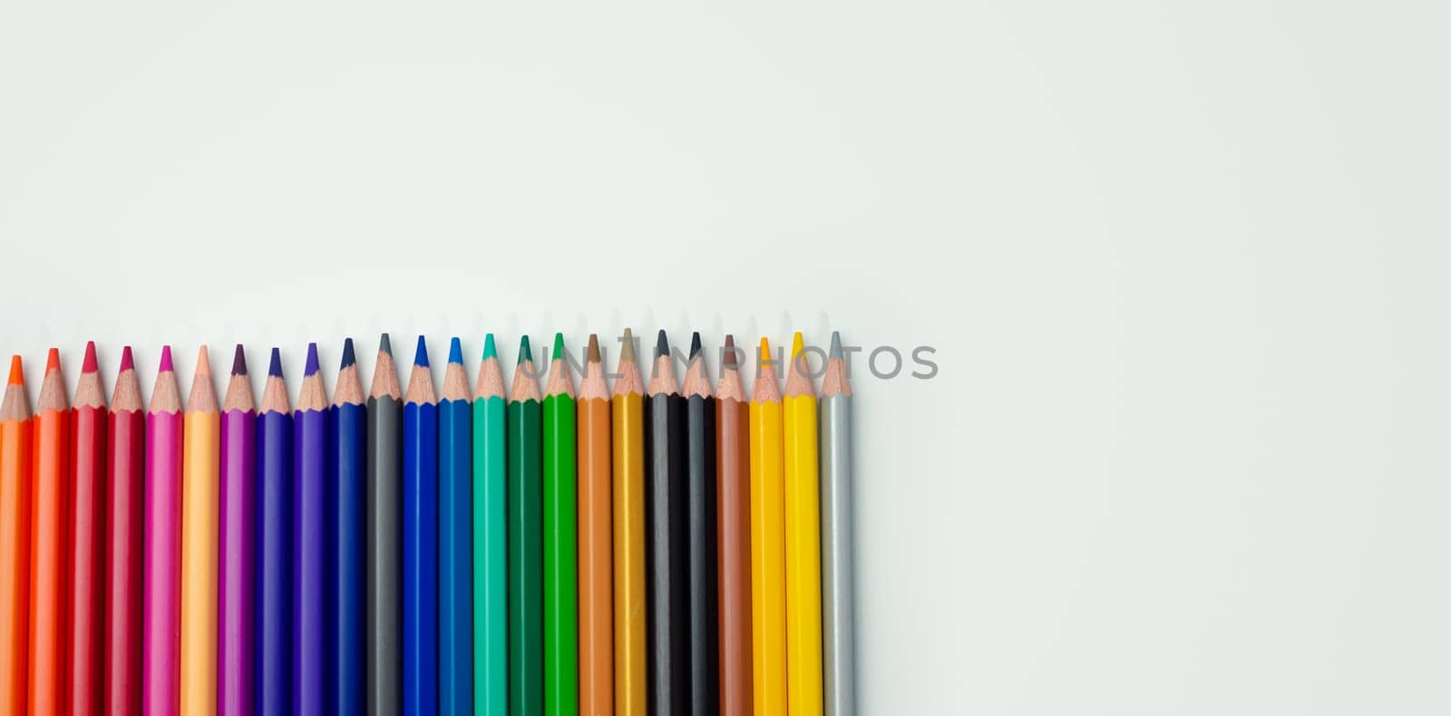 Set of colored pencils on a white background That is arranged in a bar graph, Color pencils on white background, Close up, seamless colored pencils row with wave on lower side, line pencils.