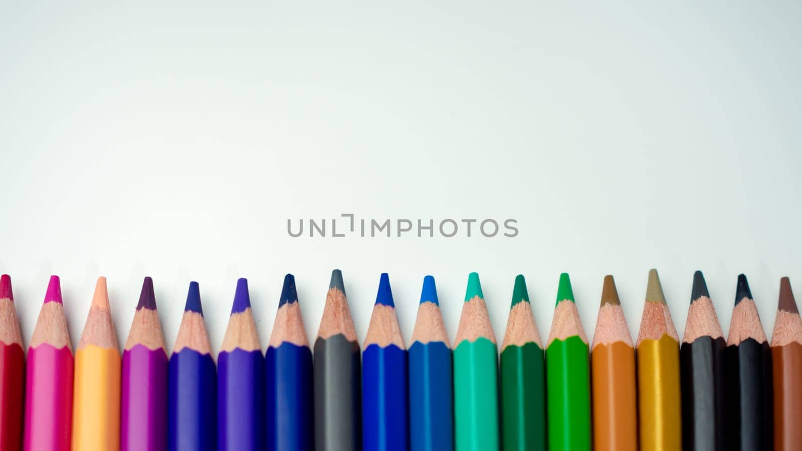 Set of colored pencils on a white background That is arranged in a bar graph, Color pencils on white background, Close up, seamless colored pencils row with wave on lower side, line pencils.