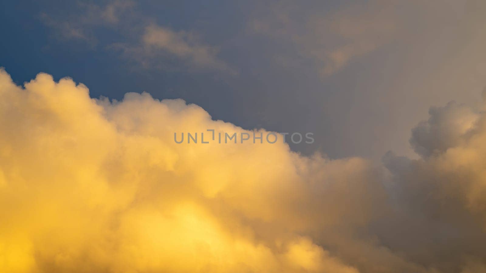 Big yellow cloud in the sky in the evening sun