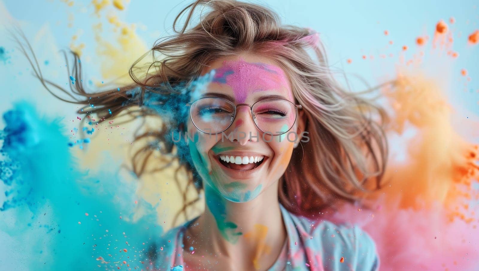 Young woman covered in colorful powder