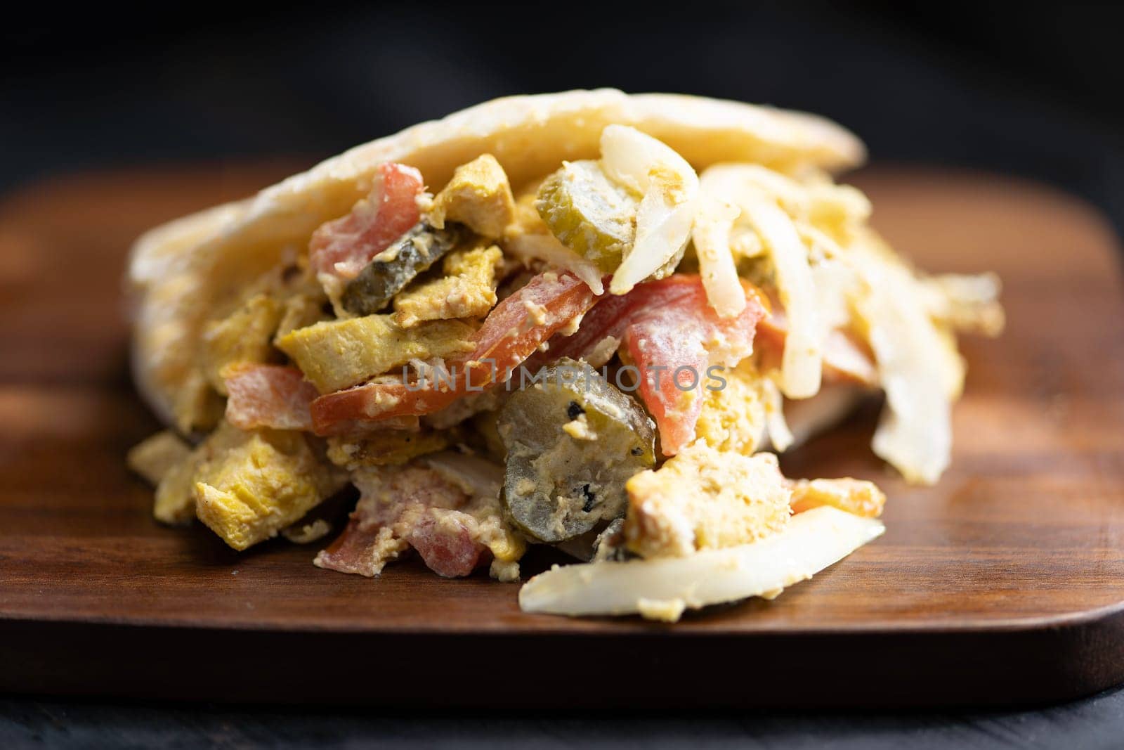 close up of greek chicken pita sandwich