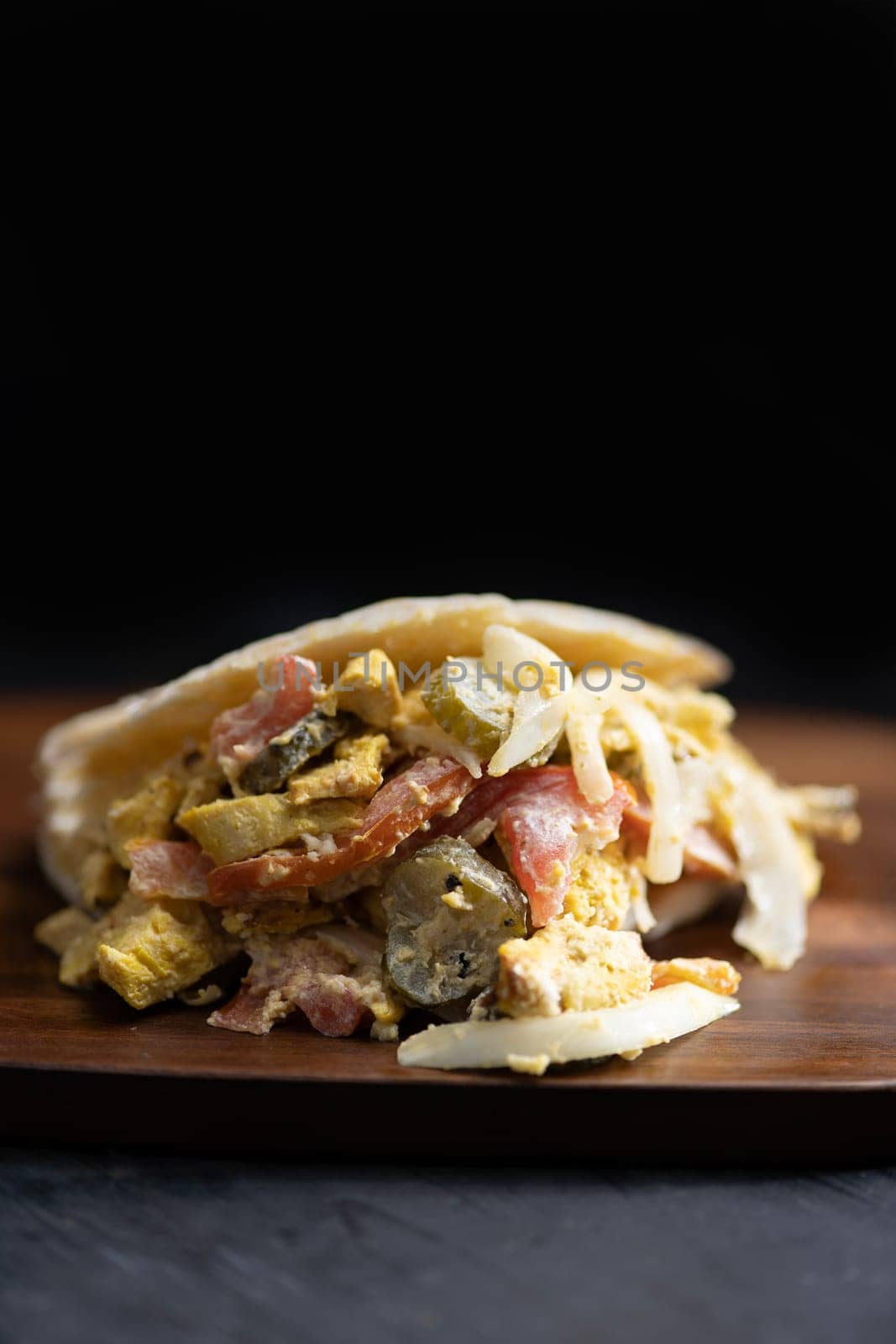close up of greek chicken pita sandwich