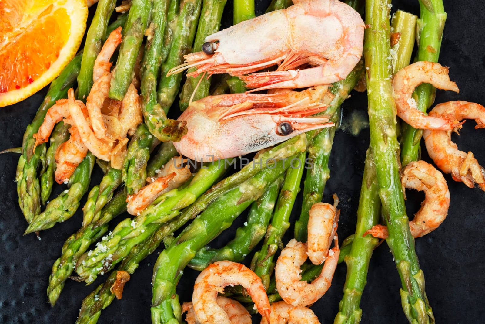 Delicious boiled shrimp with green asparagus. Seafood menu.