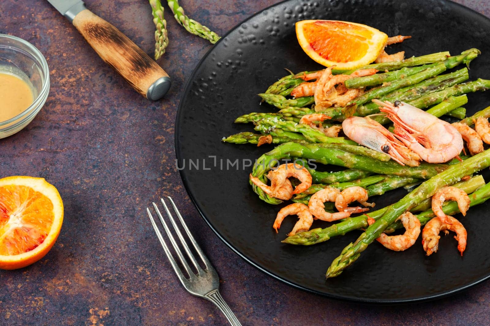 Delicious boiled shrimp with green asparagus. Seafood menu.