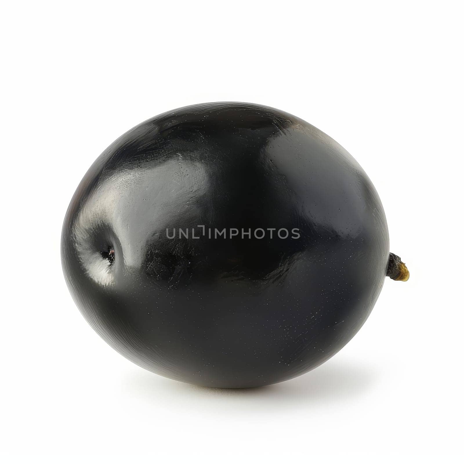 A ripe, glossy black olive with water droplets, isolated on a white background