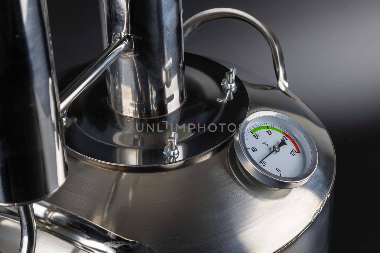 brand new stainless steel alcohol machine or moonshine still on black background.