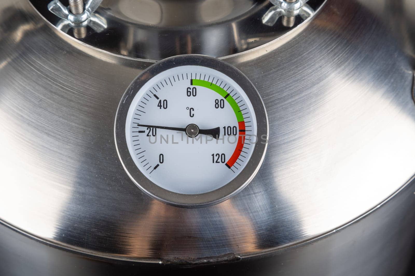 brand new stainless steel alcohol machine or moonshine still on black background.