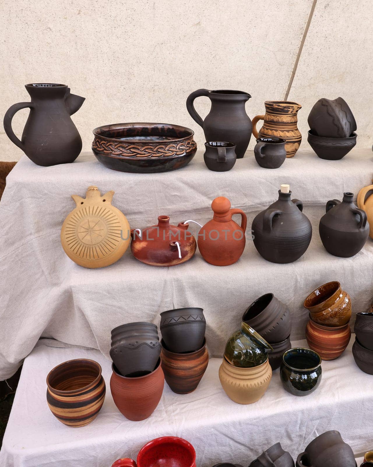 Cracow, Poland - April 11, 2023: Handmade imitations of medieval ceramic vessels in knight camp at the festival of historical reconstruction
