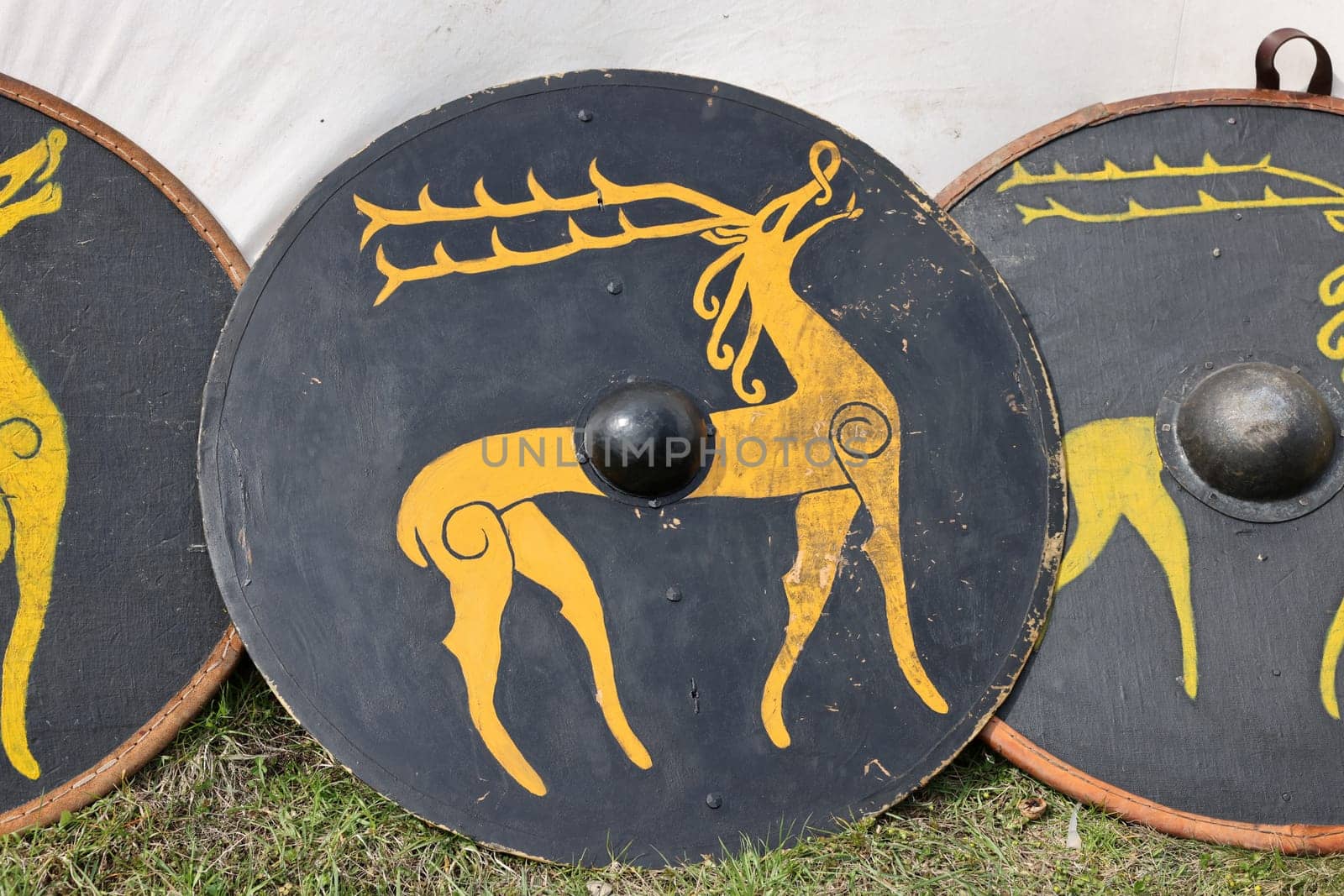 Medieval weapons, shields in knight camp at the festival of historical reconstruction