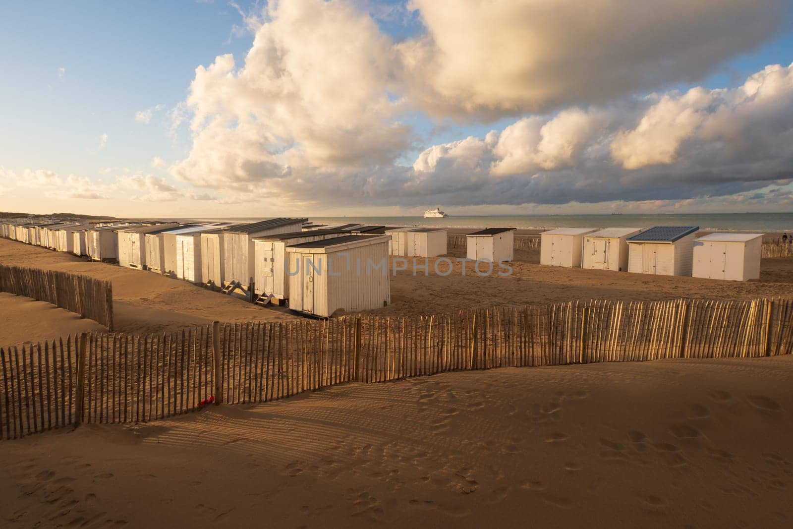 Landscape of the coast and harbor with cabins and the departure of a ferry in Calais, photographed in north of France