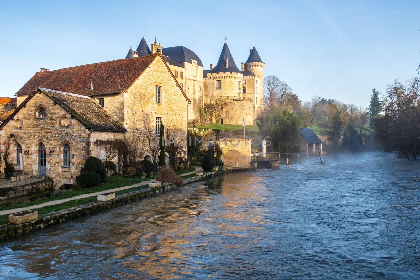 Castle and water mill over Charente River in flood in Verteuil-sur-Charente, France