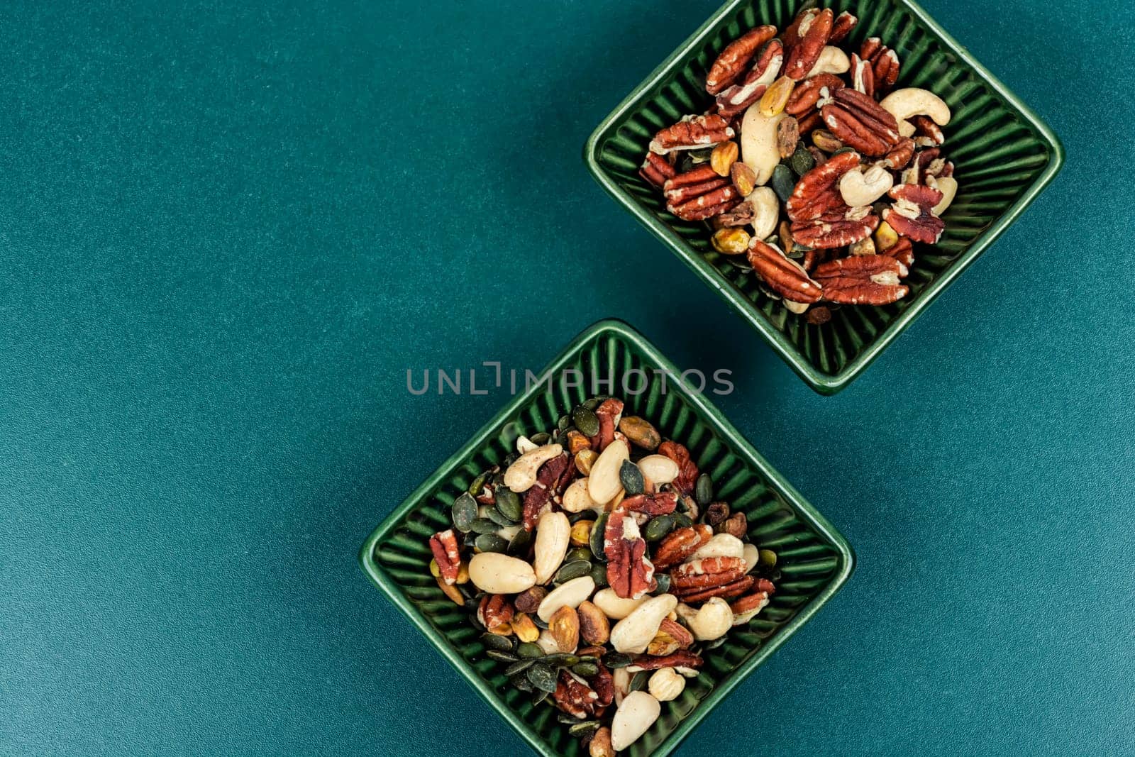 Large assortment of peeled nuts in bowl on a vintage wooden background. Superfood.