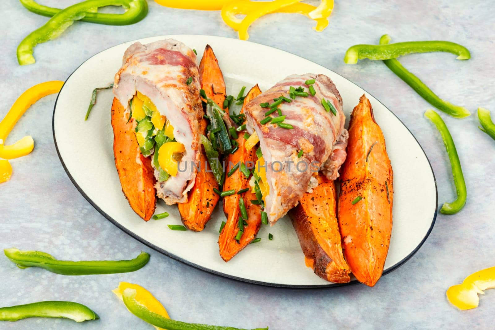 Delicious meatloaf or roulade stuffed with vegetables and baked sweet potato