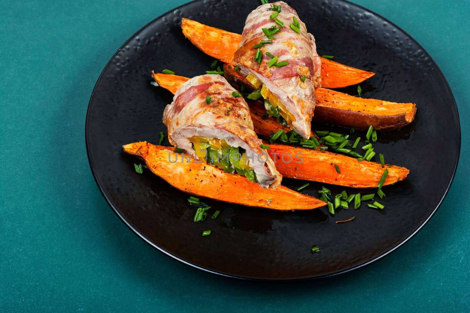 Delicious meatloaf or roulade stuffed with vegetables and baked sweet potato