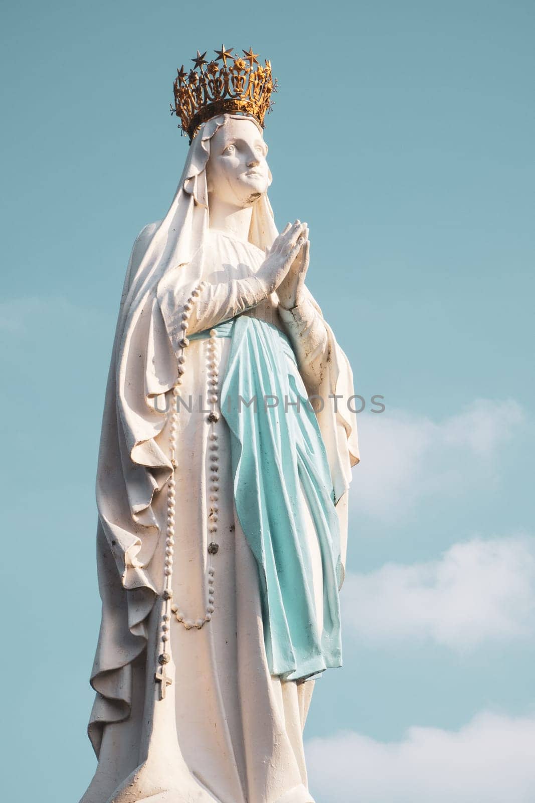 Lourdes, France - August 28, 2021: Sculpture of the crowned Virgin Mary in the Sanctuary of Lourdes, photographed in France