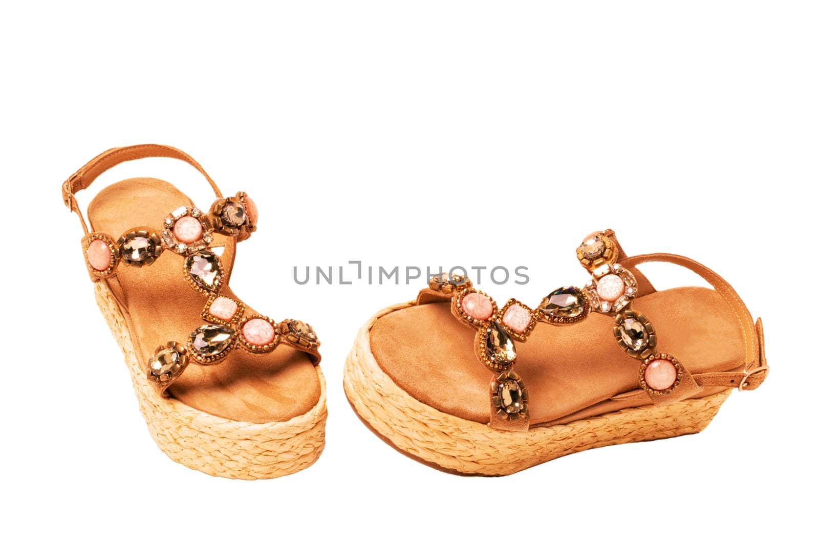 Leather shoes isolated. Close-up of a pair of elegant female suede sandals with rhinestones. Isolated on white background. Macro.