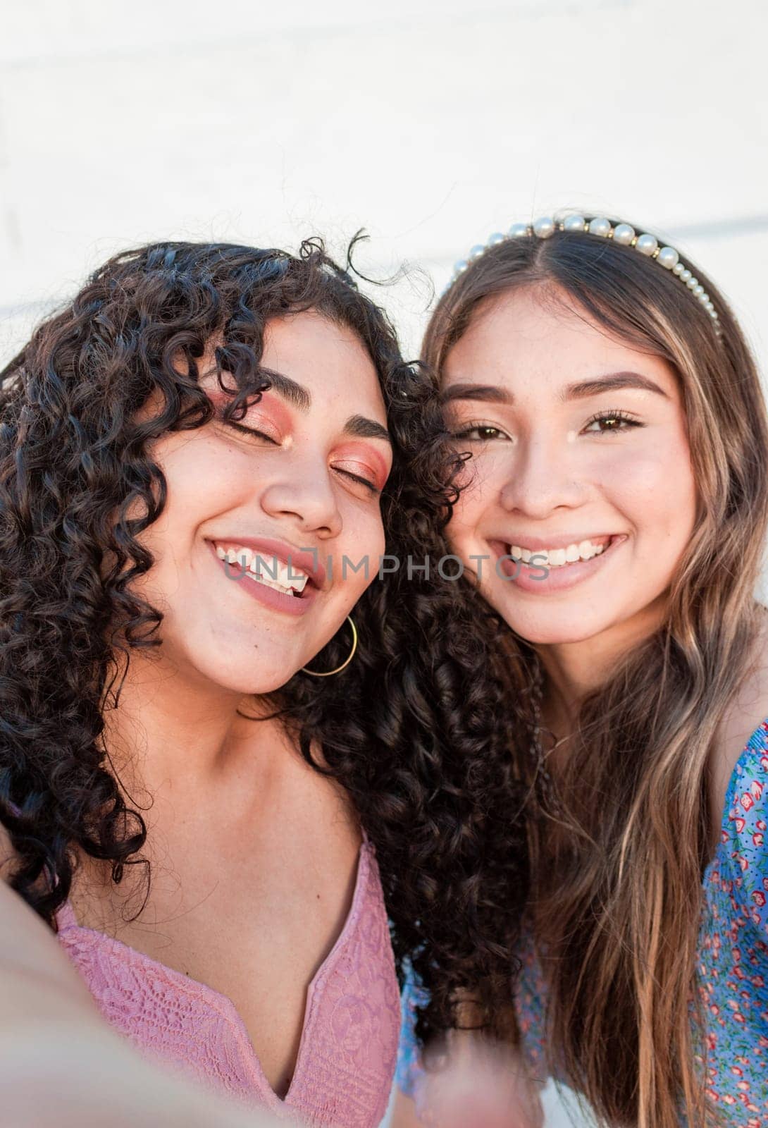 Close up of two cute girls taking a selfie, smiling girls taking a self portrait, Selfie of two girls
