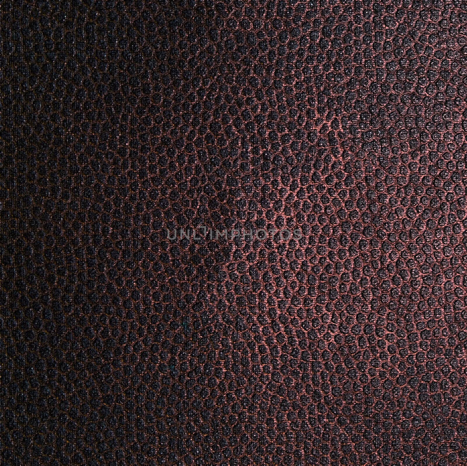The structure of a dark brown fabric in the form of a dot pattern