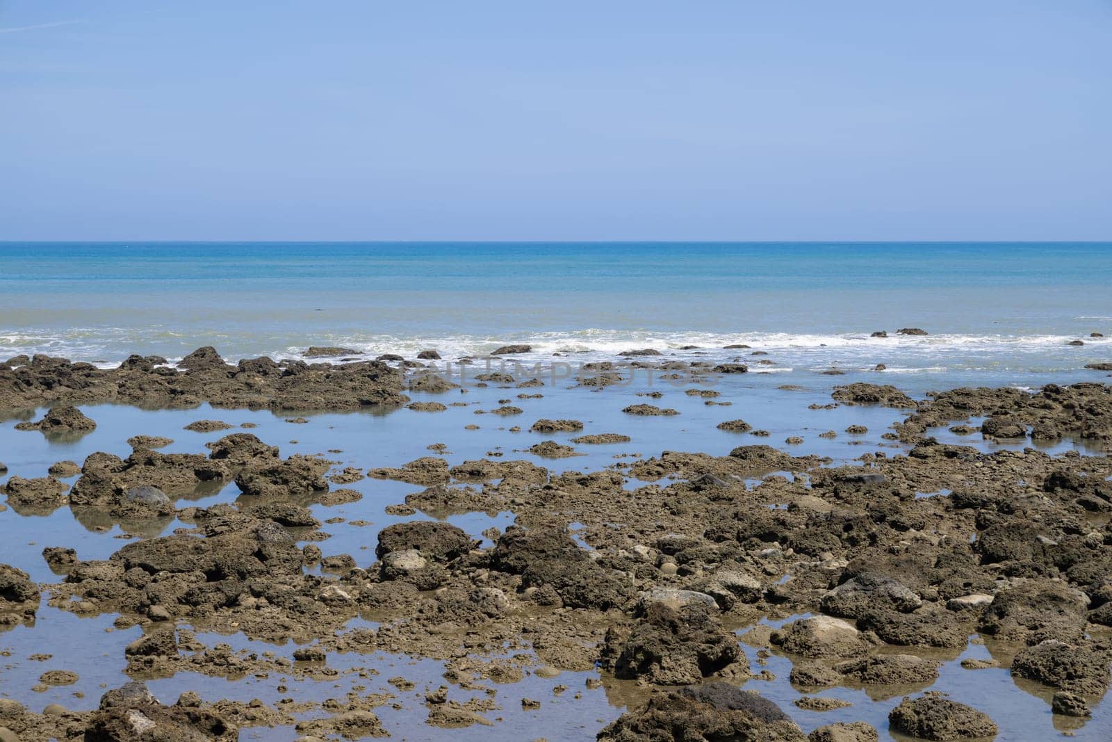 Sea rock reef with blue sky